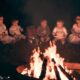 babies sitting around a bonfire