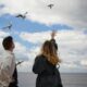 an image of a man and woman watching flying birds