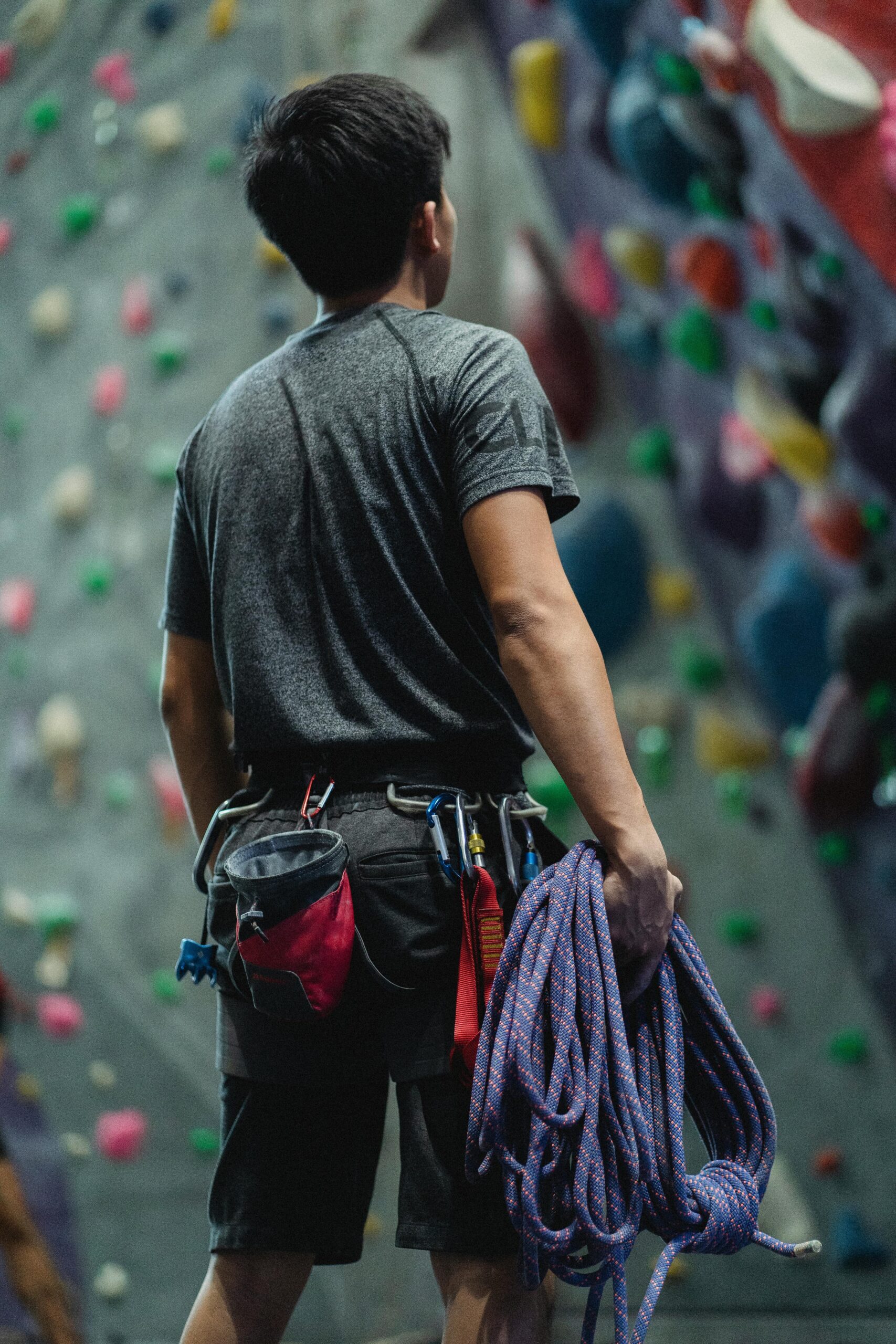 A man holding climbing ropes (Climbing gear for beginners)