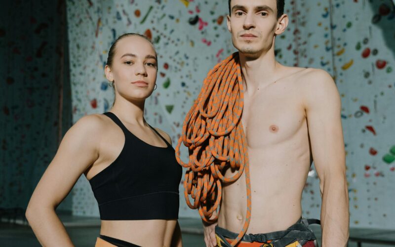 A white man and a white lady clothed in climbing gear