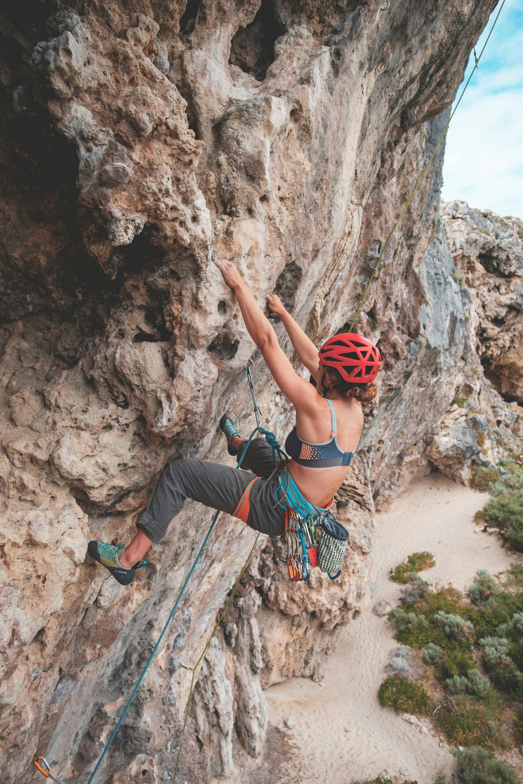 A lady climbing with a helmet