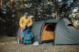 Waterproof camping storage: A man packing his camping gear